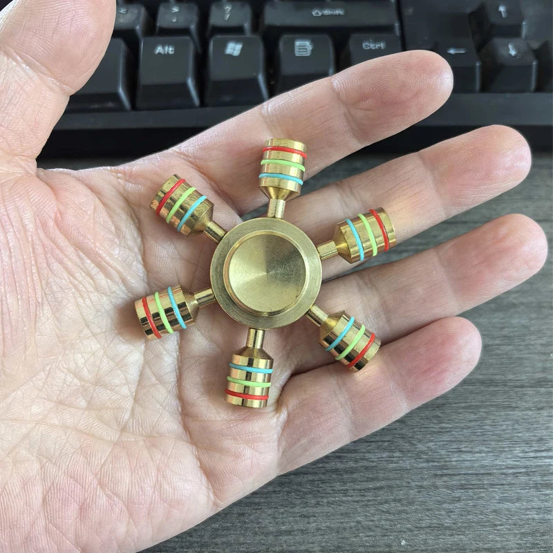 Six-arm metal fidget spinner for sensory focus and ADHD stress relief on hand