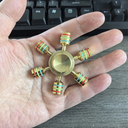 Six-arm metal fidget spinner for sensory focus and ADHD stress relief on hand
