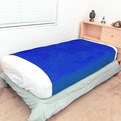 a bed with a fitted blue compression blanket for special needs covering the mattress