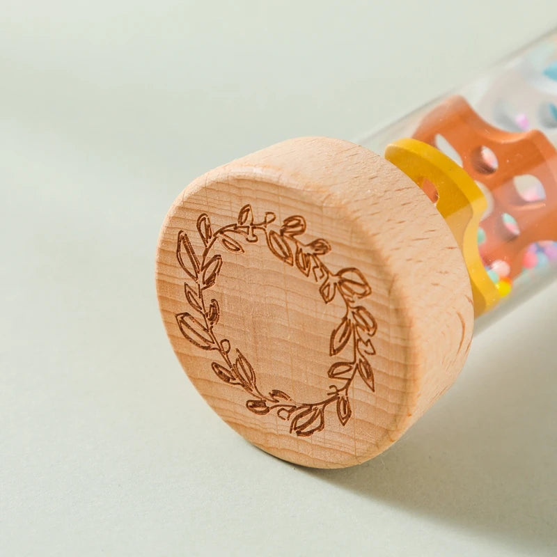 Close up view of the rain sound maker, showcasing its wooden base