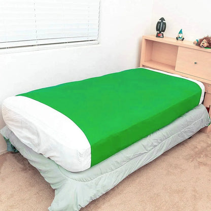 a bed with a fitted green compression blanket for special needs covering the mattress