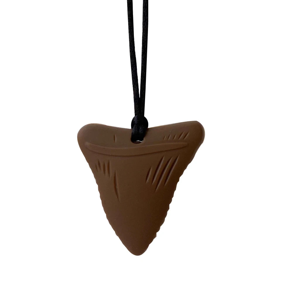 Brown shark tooth-shaped pendant on a black cord against a white background