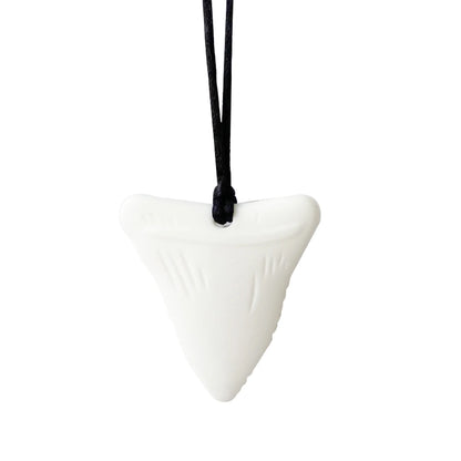 White shark tooth pendant on a black cord against a white background