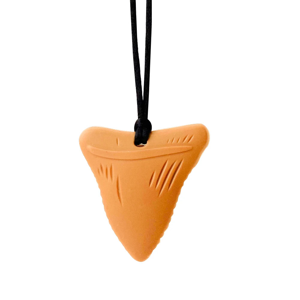 Orange shark tooth-shaped pendant on a black cord against a white background