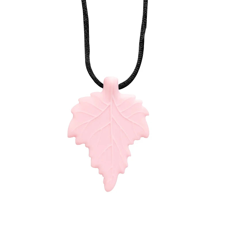 Pink leaf-shaped pendant on a black cord against a white background