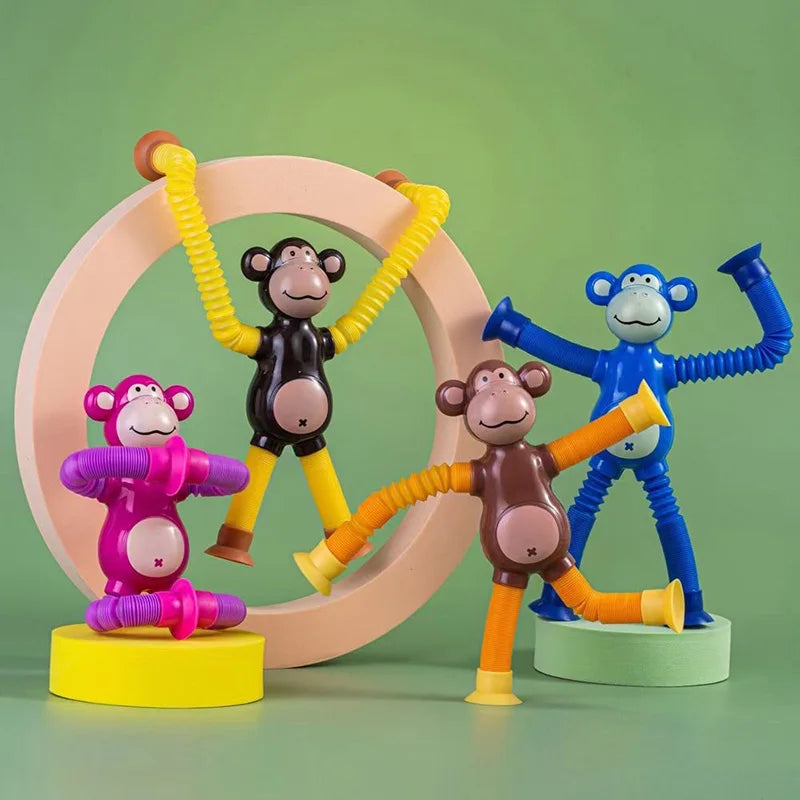 Colorful monkey-themed stretchy pull tube fidget toy on a green backround right