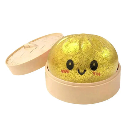 Dumpling Squishy Stress Ball – Cute Glitter Sensory Fidget Toy in a dim sum container, gold color, perfect sensory toy for kids and adults.