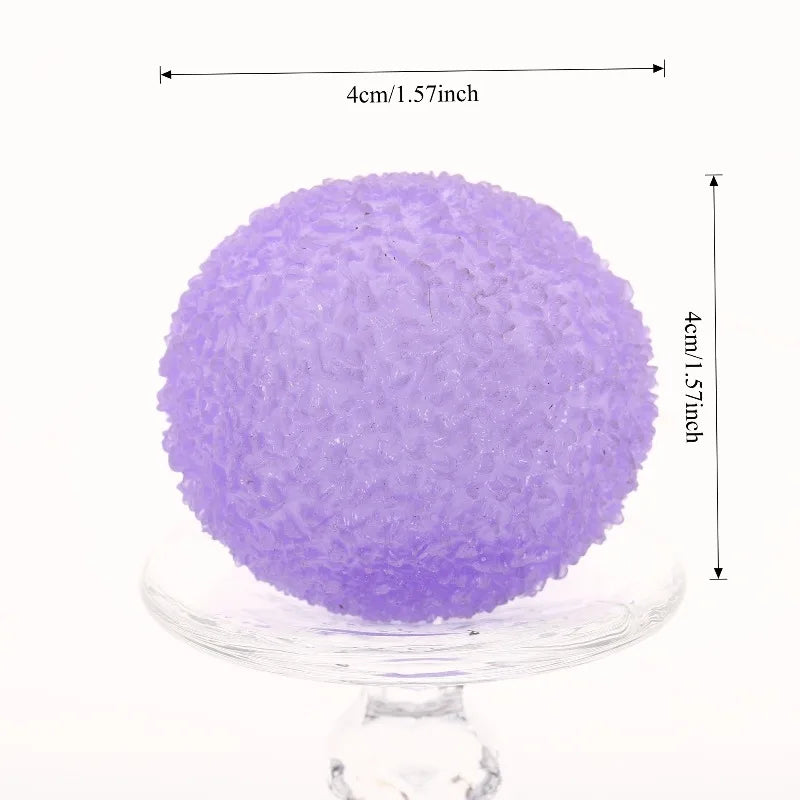 Purple textured stress ball on a clear stand with measurements indicated
