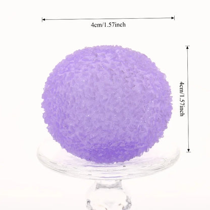 Purple textured stress ball on a clear stand with measurements indicated