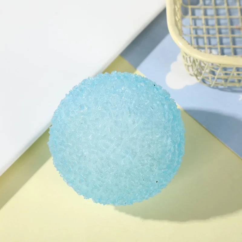 Blue textured stress ball on a light yellow surface with a white background