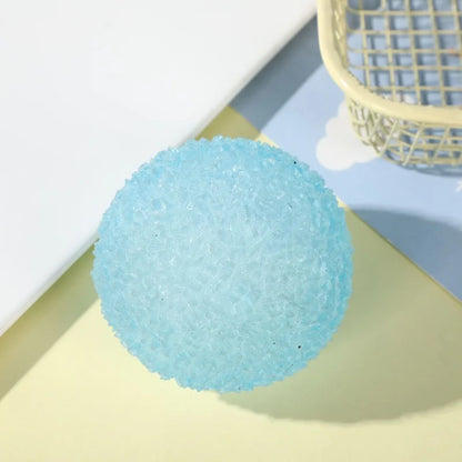Blue textured stress ball on a light yellow surface with a white background