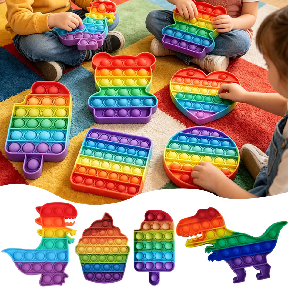 Rainbow Pop-It Fidget Toy — Assorted Shapes, colorful sensory toys for kids on a playful rug.