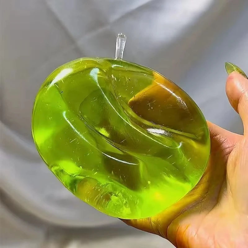 Green apple squeeze toy for stress relief and sensory stimulation demonstration when squished